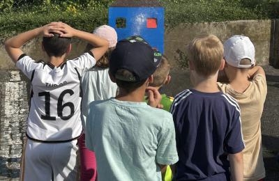 Kinder spritzen mit Wasser auf eine Schablone