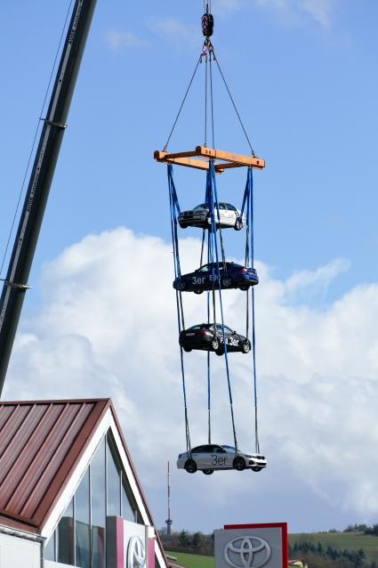Autos hängen an einem Kran